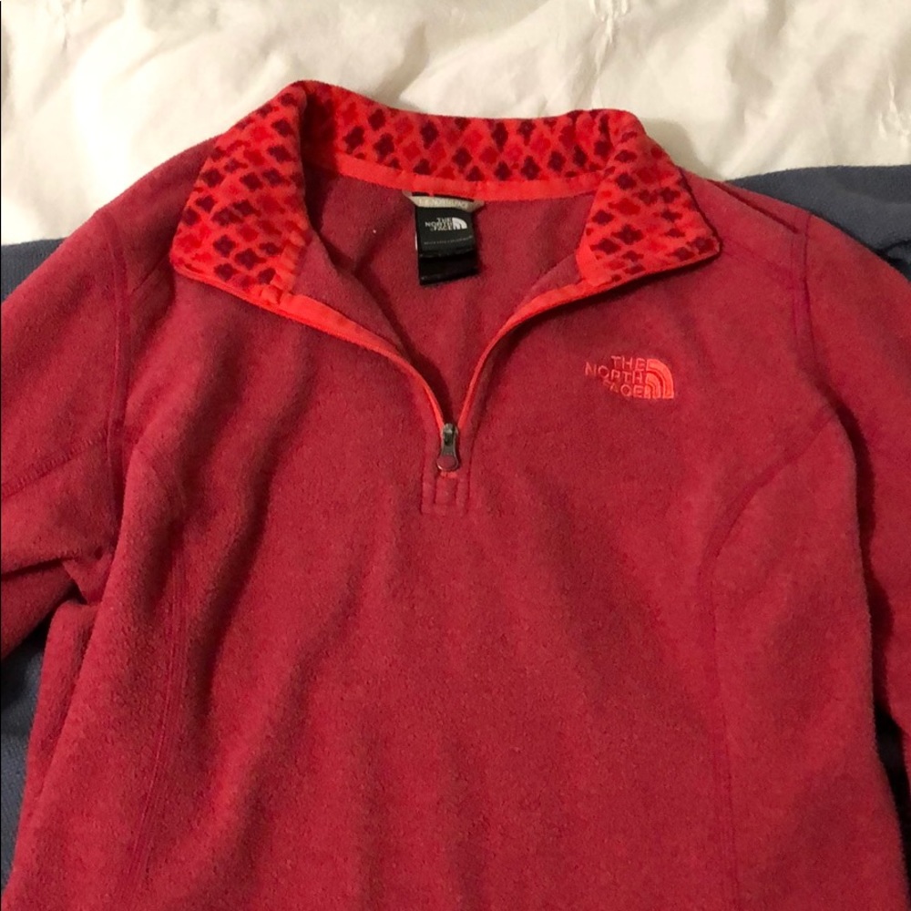 Red and pink women’s north face pull over